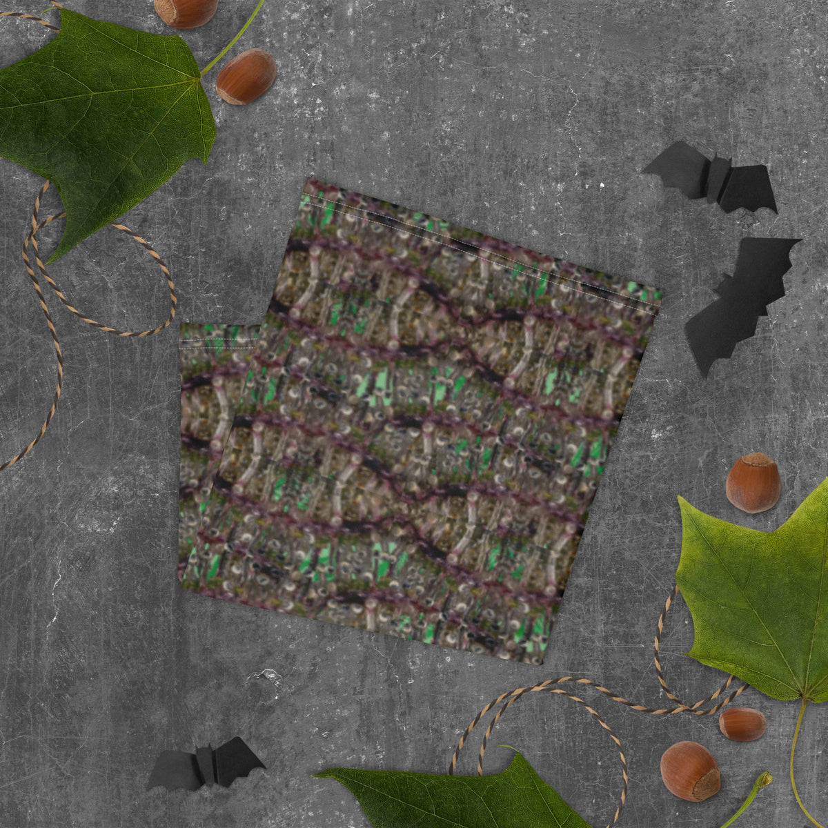 White dripping bud neck gaiter by BudWear, all-over-print fabric, folded to showcase the vibrant cannabis leaf design.