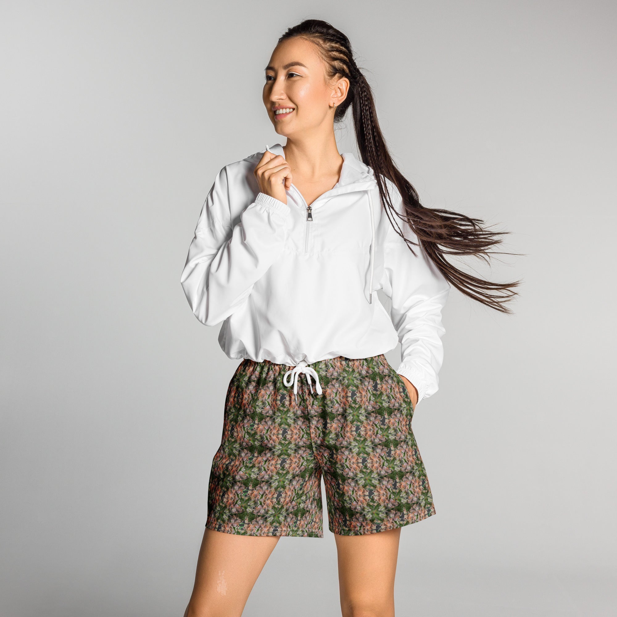 All-over white unisex athletic long shorts with Buddy Athletic print by BudWear, featuring a comfortable fit and sporty design.