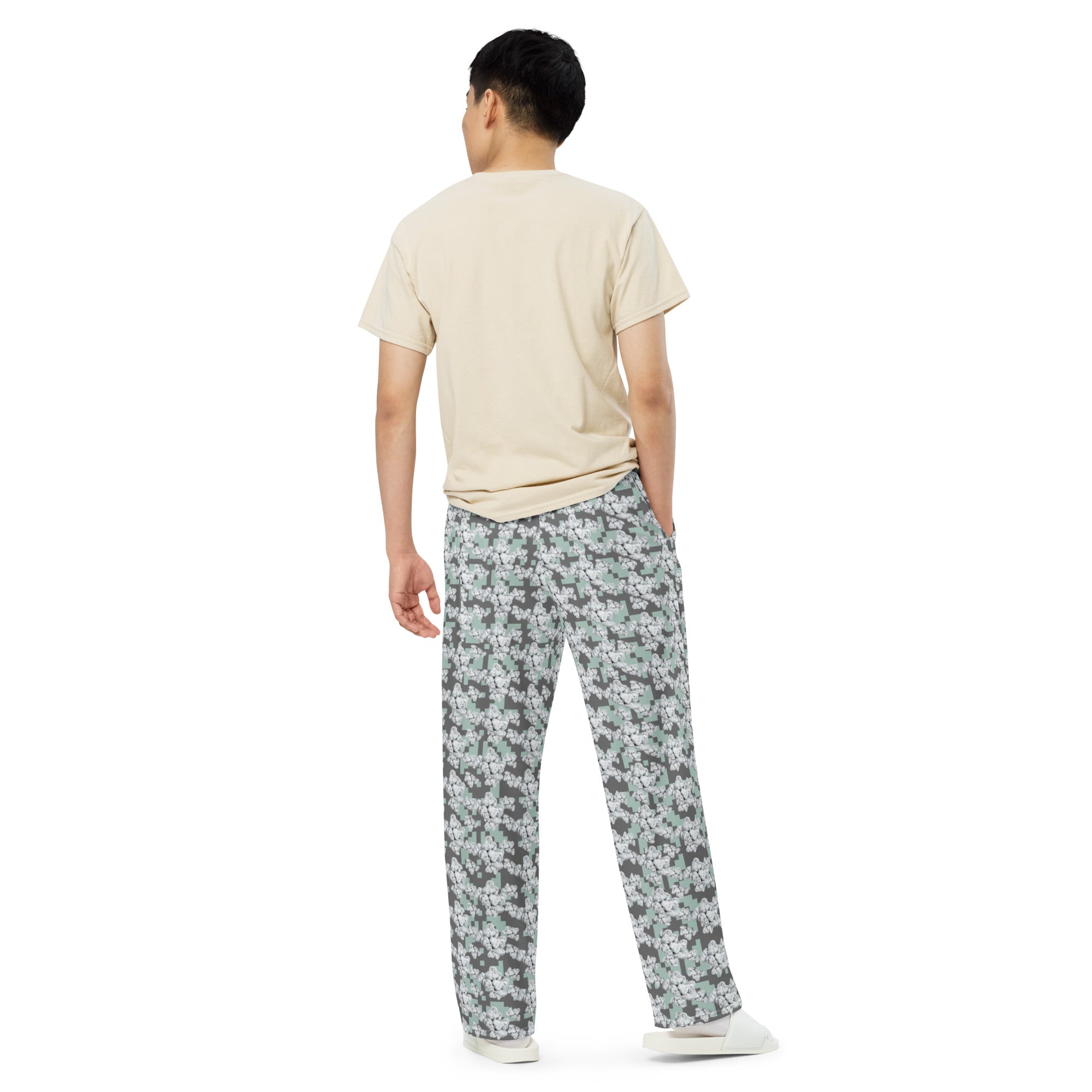 White wide-leg unisex CUT-SEW pants with all-over print from BudWear, shown from the back view.