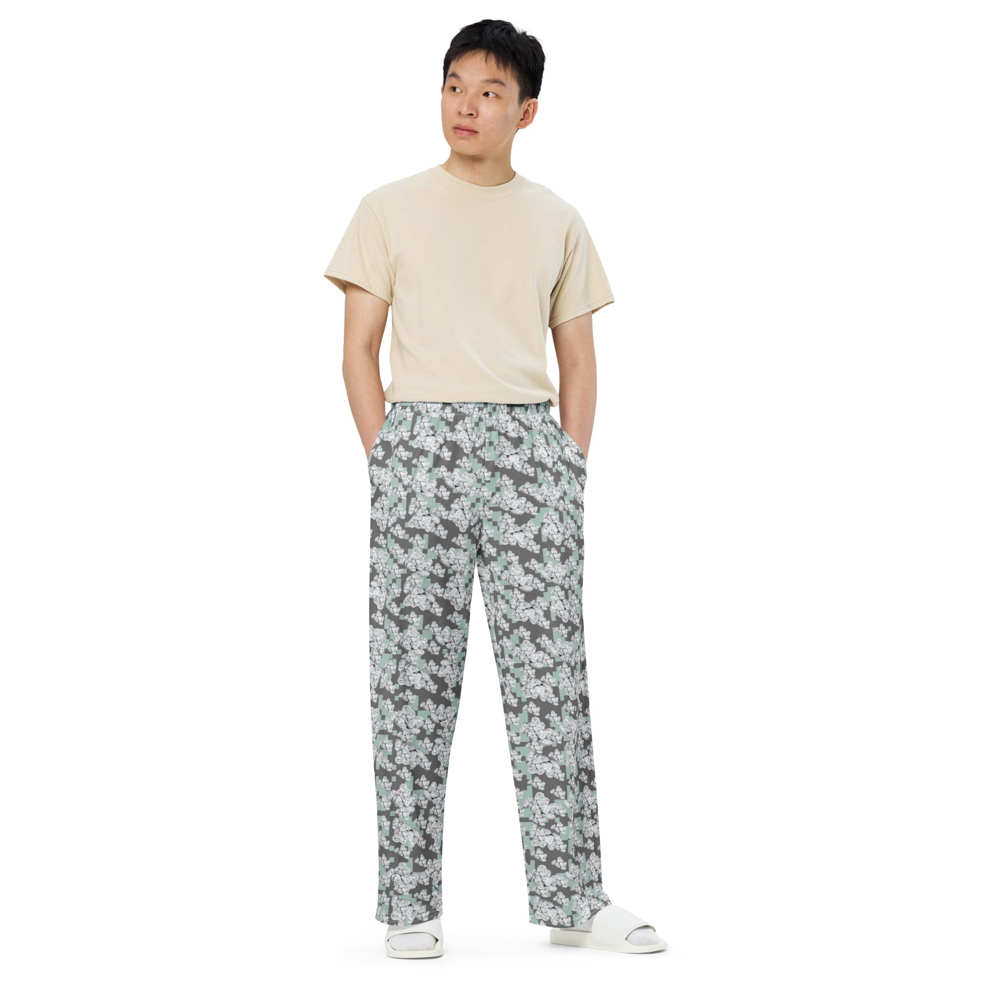 White unisex wide-leg CUT-SEW pants from BudWear with all-over print, featuring a relaxed fit and casual style.
