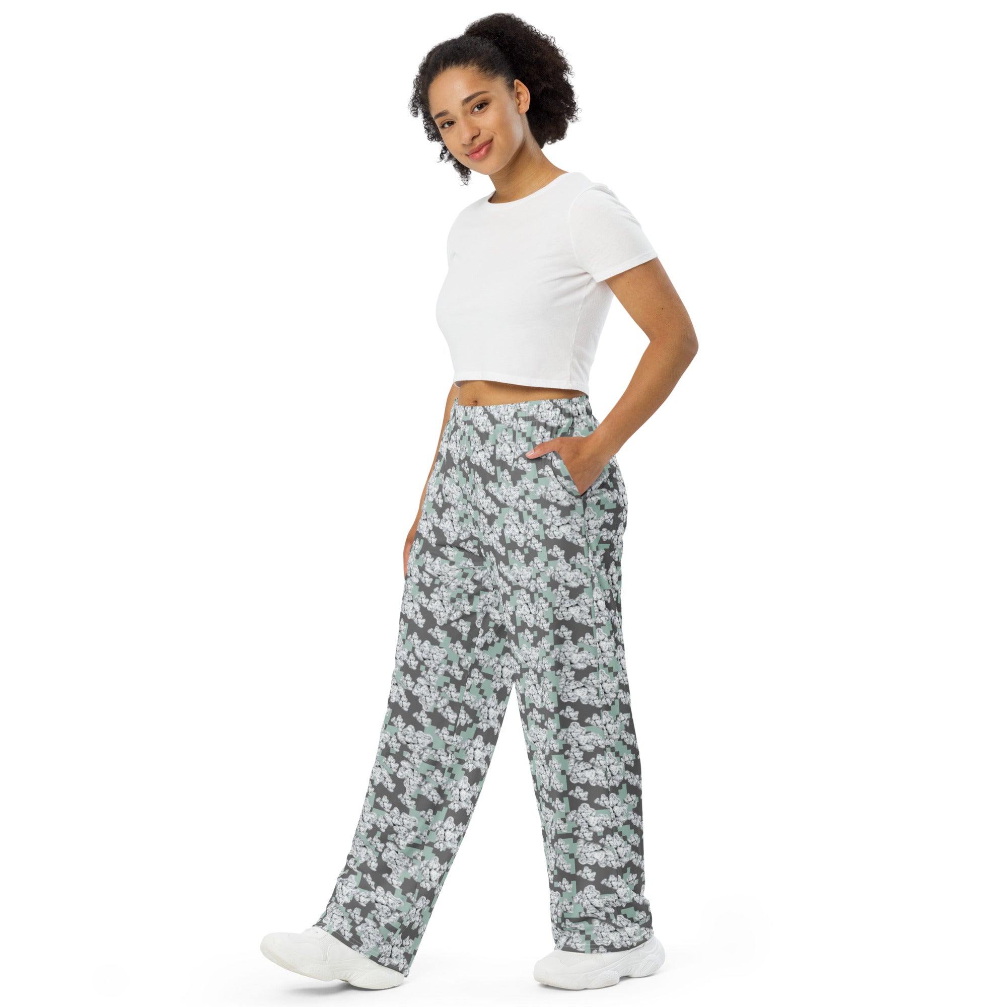 Unisex white wide-leg cut-sew pants with all-over print from BudWear, shown from the left front angle.