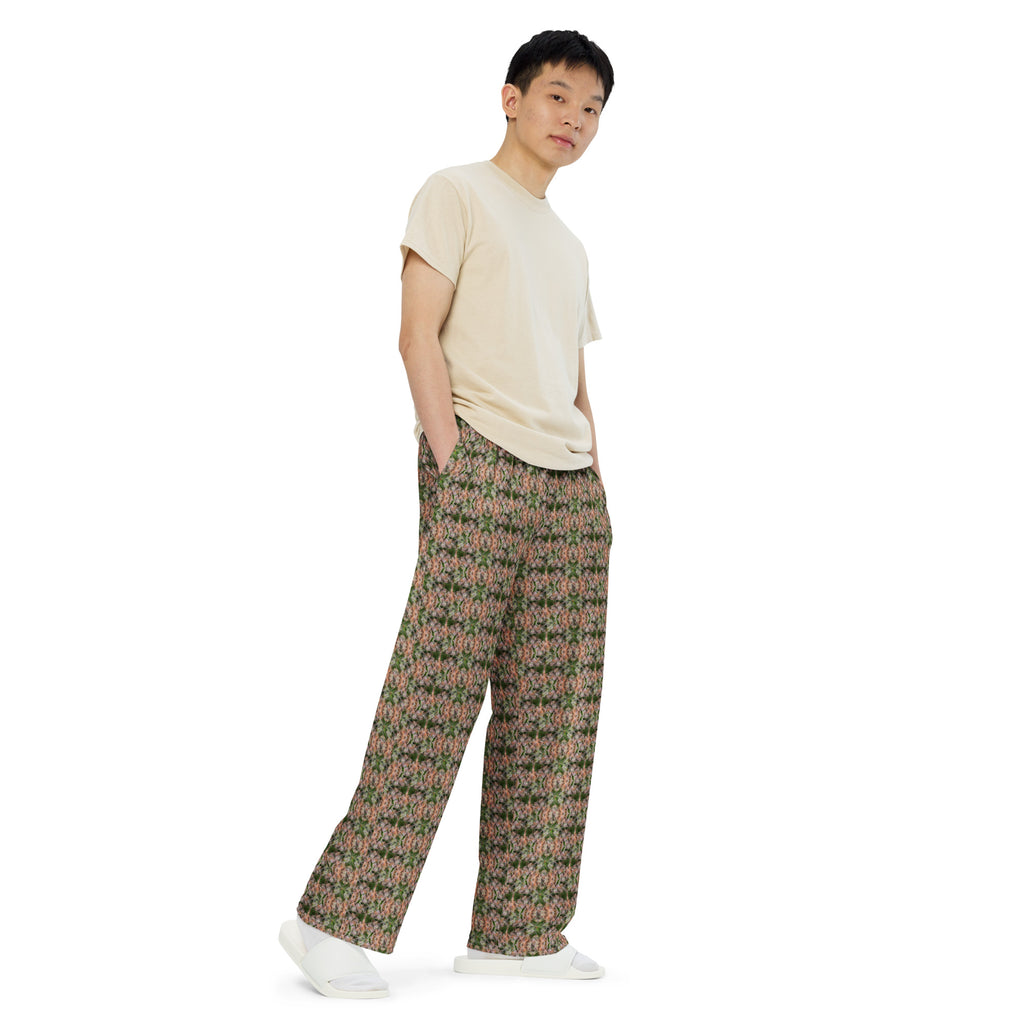 Unisex wide-leg pants by BudWear with all-over floral print, white fabric, and relaxed fit, shown from the right front angle.