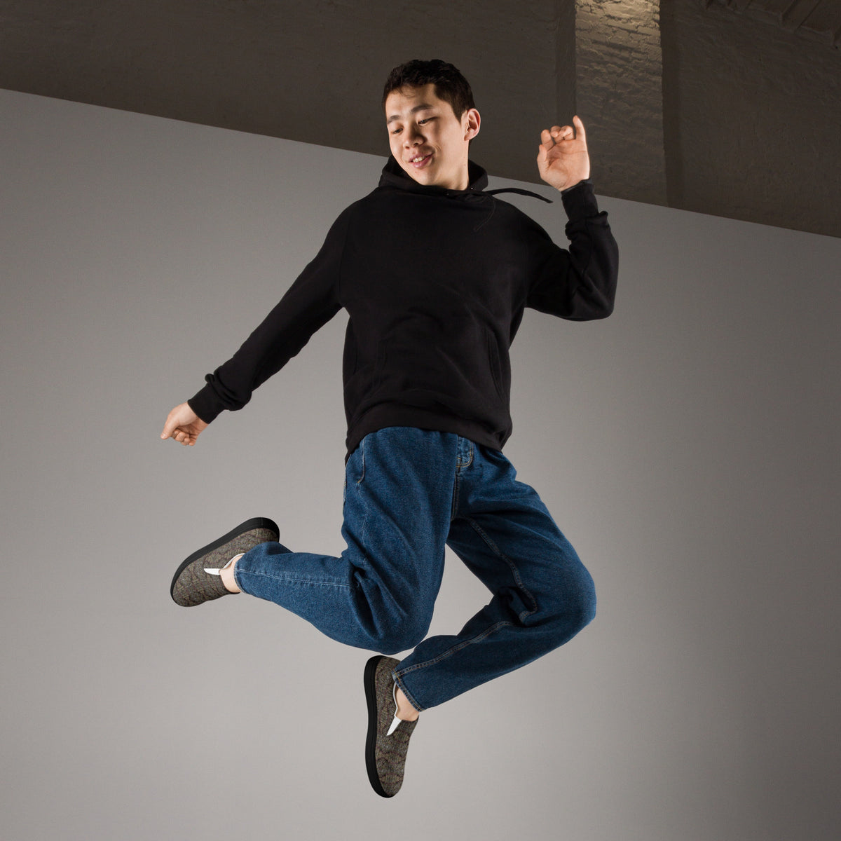 Men's black Tricoman Canvas Slip-On Shoes by BudWear, showing the right front view with a sleek, comfortable design.